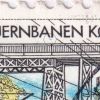 1148[#CK]: Cyan farvestreg på skrå under JERNB[AN]EN KØBENHAVN-ROSKILDE 150 ÅR.
Ukendt arkplacering.